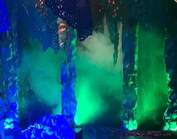 A stage with green and blue lights Description automatically generated