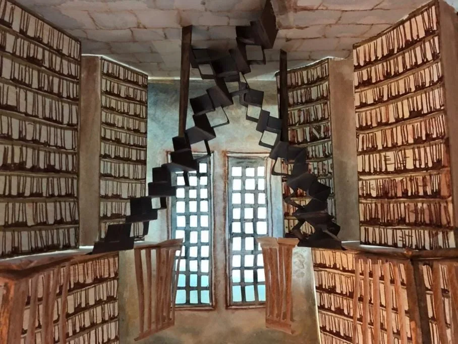 A spiral staircase in a room Description automatically generated