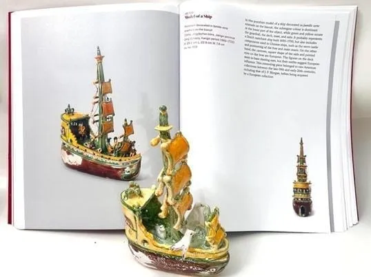 A book with a model of a ship Description automatically generated