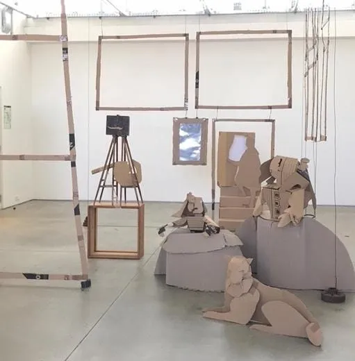 Cardboard sculptures in a room Description automatically generated