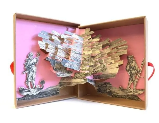 A box with cut out pieces of paper Description automatically generated